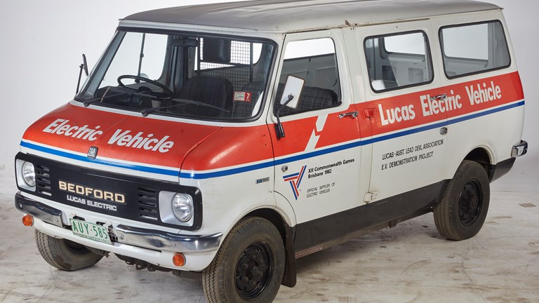 a photo of a white van with red and blue stripes across the side