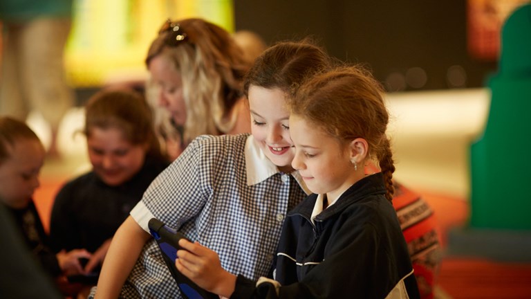 rimary school students using iPads during the 'Place and Culture' program in the First Peoples exhibition, Bunjilaka, Melbourne Museum.