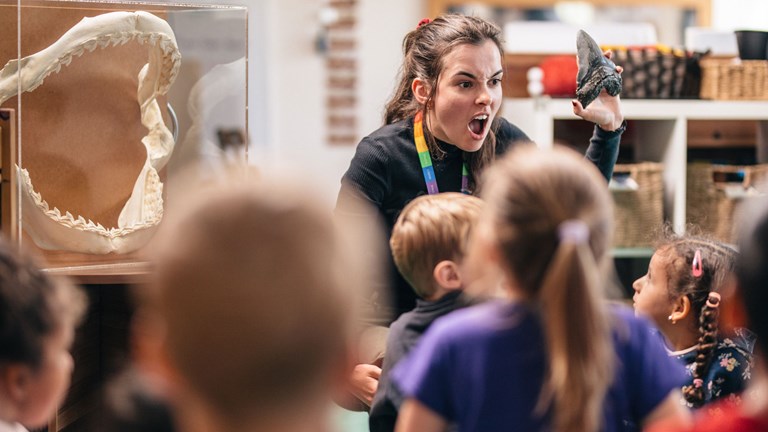 Children learn about a Megaladon shark tooth and as they learn about sharks in the Ocean Wonders presentation