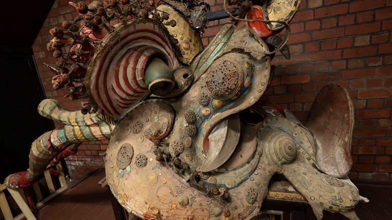 the head of a Chinese dragon resting on a plinth