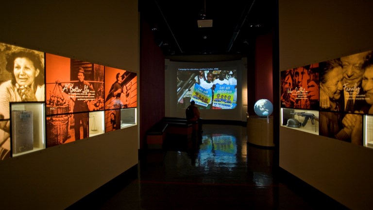 A film theatre with museum exhibits in the left and right hand side of the screen.