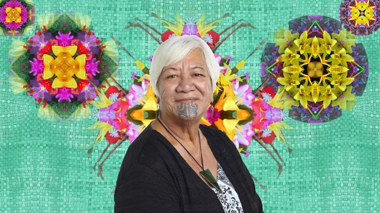 Woman with a tattoo on her chin. The background is a green woven plant fibre with digital flowers