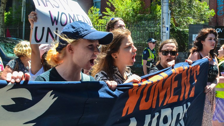 Group of women holding a protest banner
