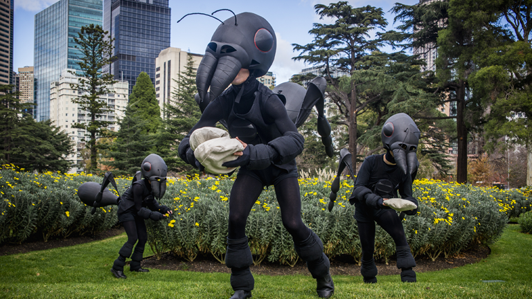 Three worker ants in costume outside in the Carlton Gardens.