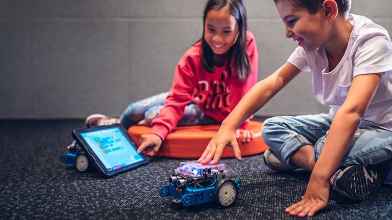 Children programming an mBot.